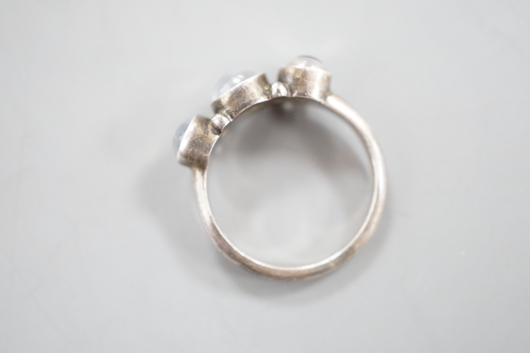 A Georg Jensen sterling 925 and three stone cabochon moonstone set half hoop ring, no. 3, size M/N, in Georg Jensen box.